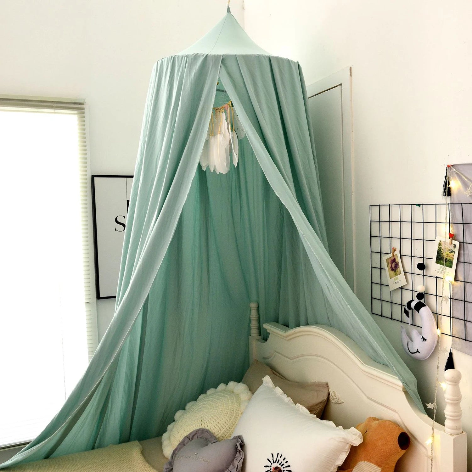 Mint green canopy over a bed in a bedroom setting