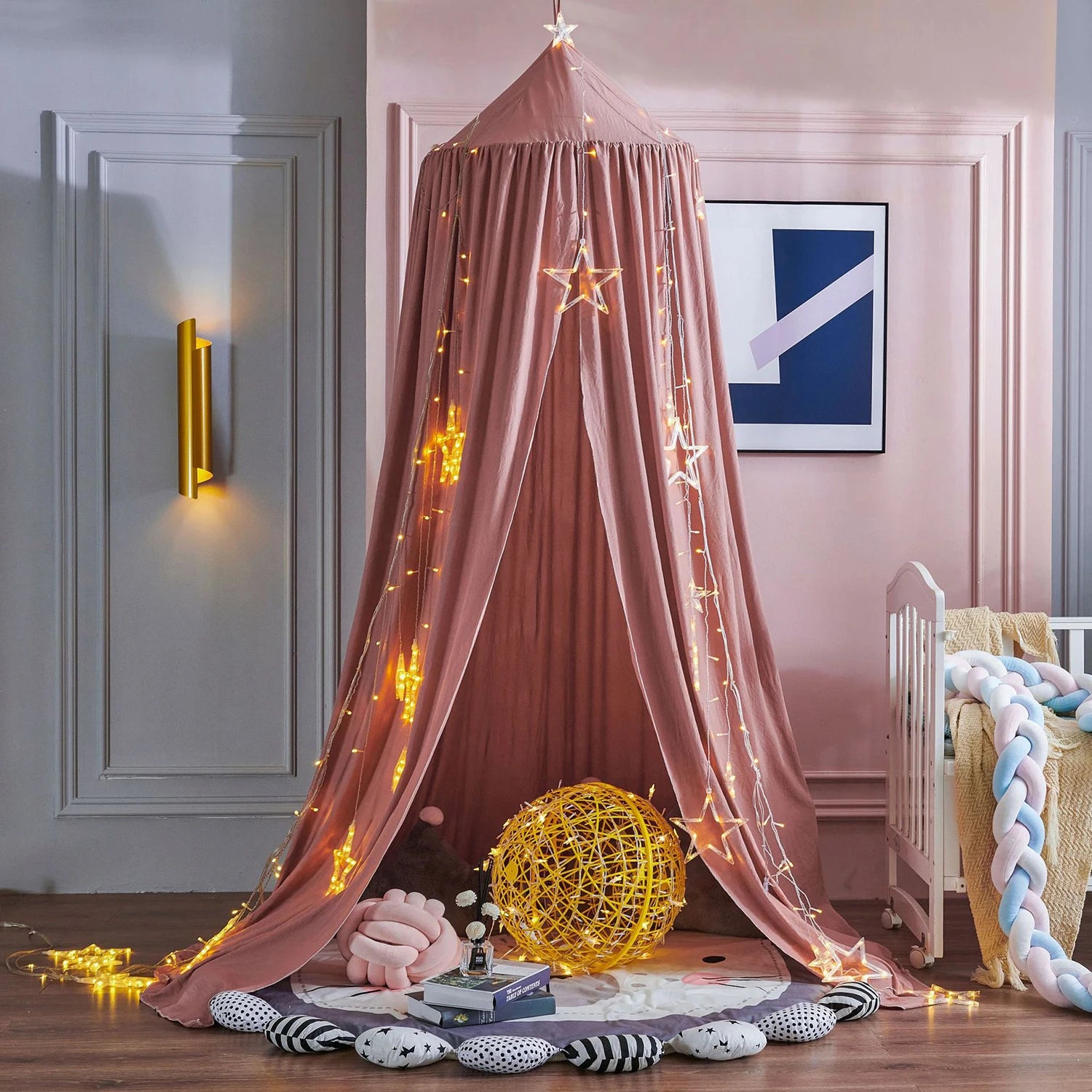 Pink canopy with string lights in a child's room