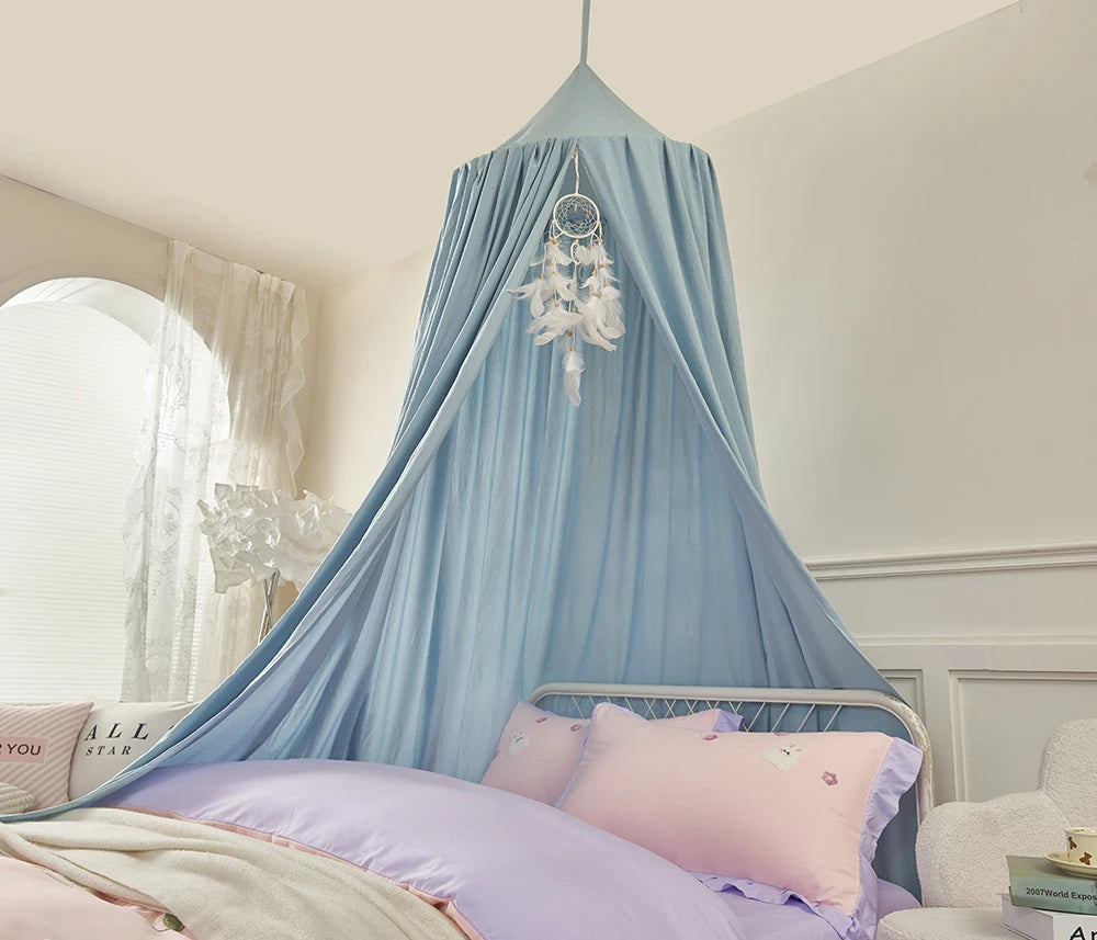 Blue canopy over a bed with pink bedding in a bedroom setting